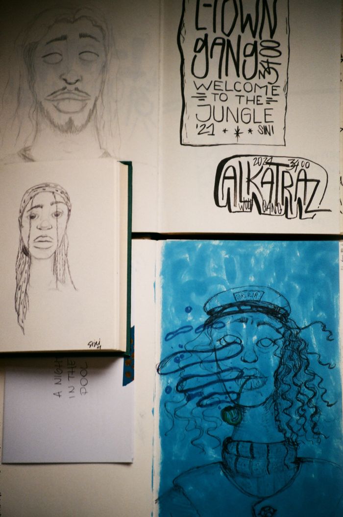 Collection of artistic sketches with creative typography in a sketchbook.